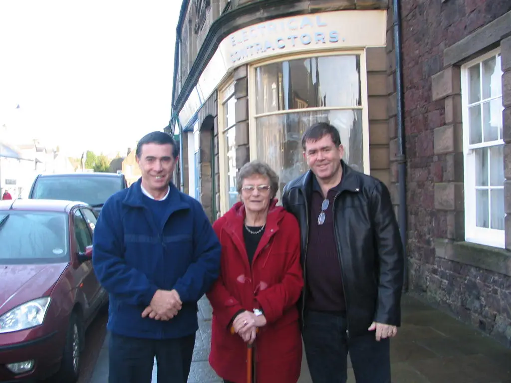 Dan Shiels, David French & Meryl Harris in front of former Shiels the Bootmaker shop in Biggar, Scotland